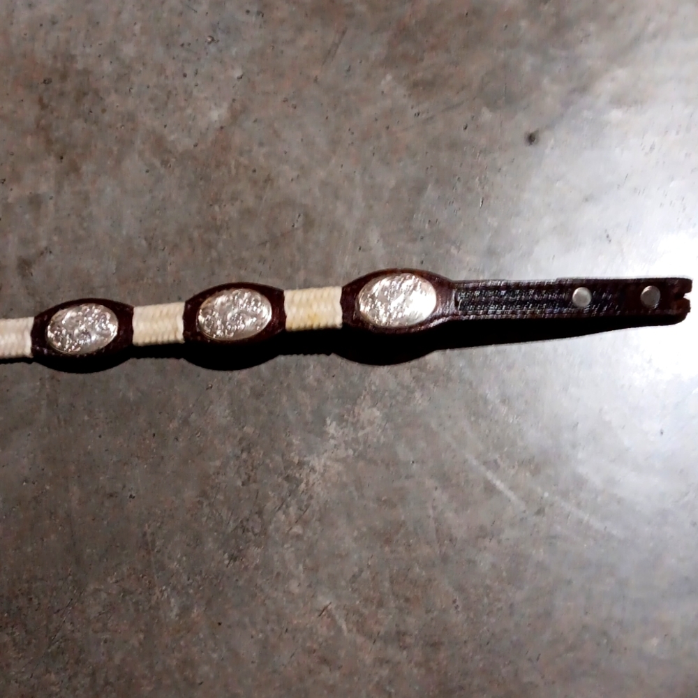 Women's size 28 belt made with leather and sliver decorative designs.